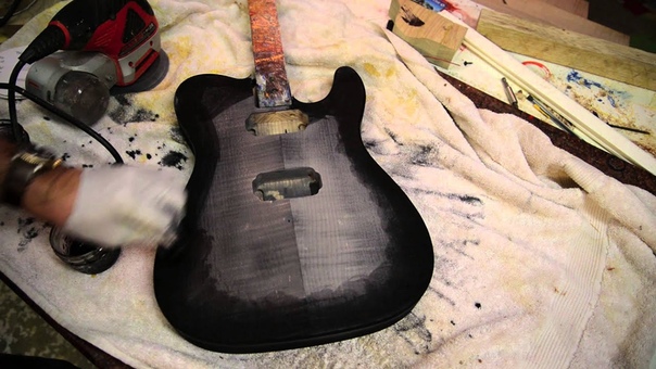 Black burst bursting a flame maple guitar with water based